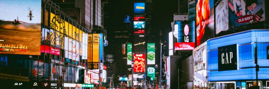 Illuminated billboards and bustling crowds at iconic Times Square, NYC, during the night.