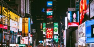 Illuminated billboards and bustling crowds at iconic Times Square, NYC, during the night.